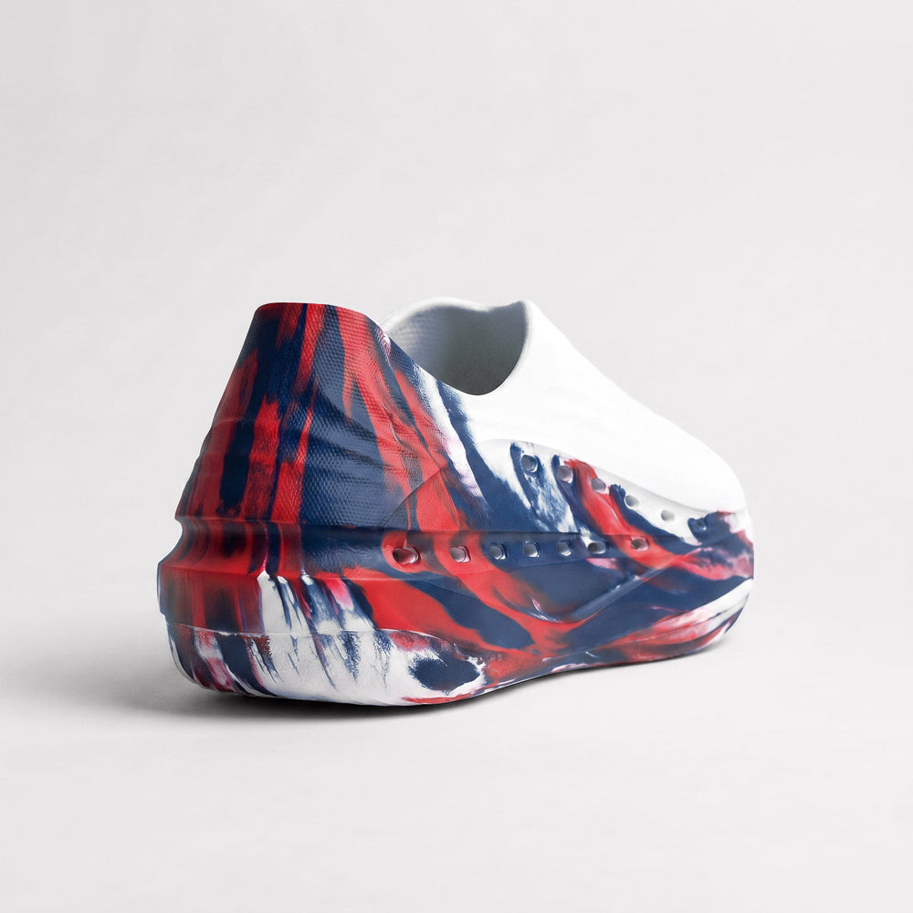 Shoe with a red, blue, and white abstract pattern on a light gray background