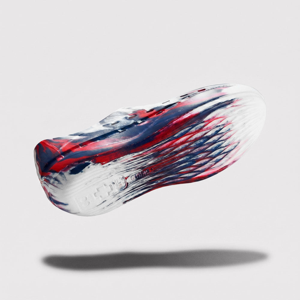Colorful shoe with red, white, and blue design on a light gray background